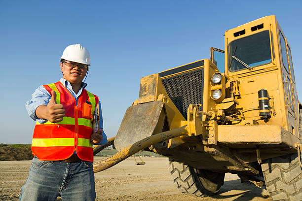 a construction site safety inspector gives the thumbs up.
